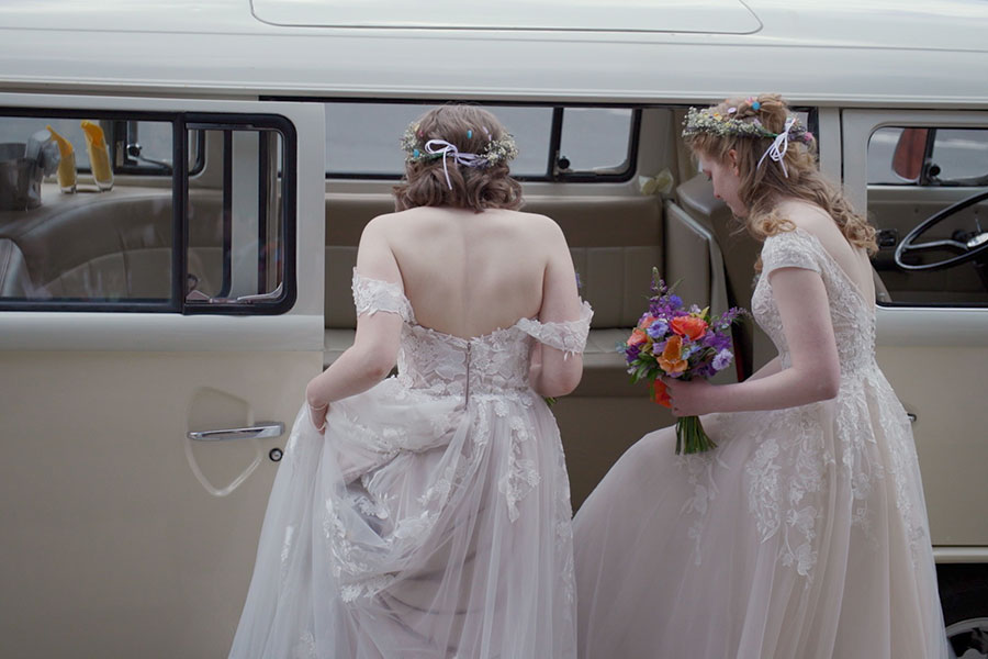 Brides Fran and Izzy getting into their camper van transport after their wedding in Eastbourne to head to their wedding reception at Eastbourne tennis club
