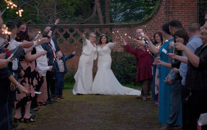 Still of the brides and friends holding sparklers from Sheryl and Jodies's wedding filmed in Staffordshire by Wedding Stories by Hannah Quinn