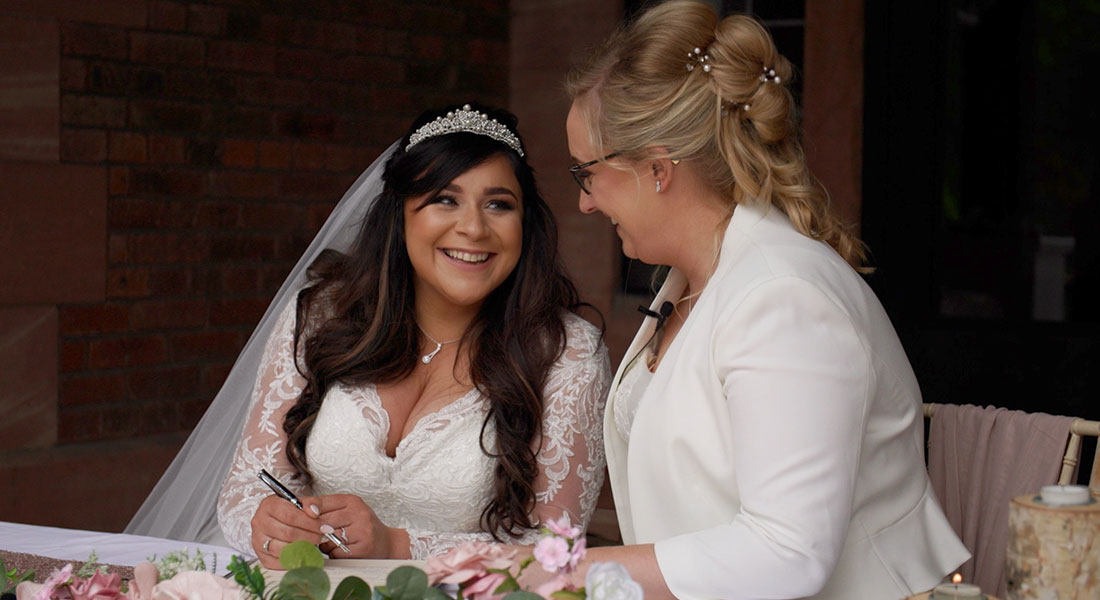 Still of the brides laughing and smiling at the ceremony from Sheryl and Jodies's wedding filmed in Staffordshire by Wedding Stories by Hannah Quinn