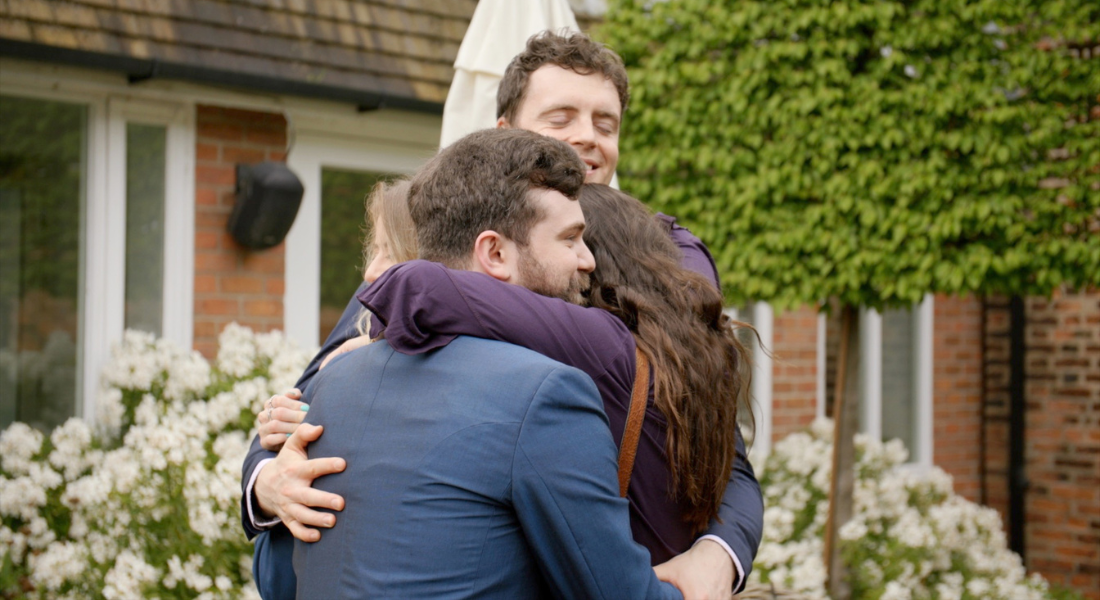 Image shows Groom Rob's friends hugging and congratulating him after his marriage at the Manor House Hotel in Alsager